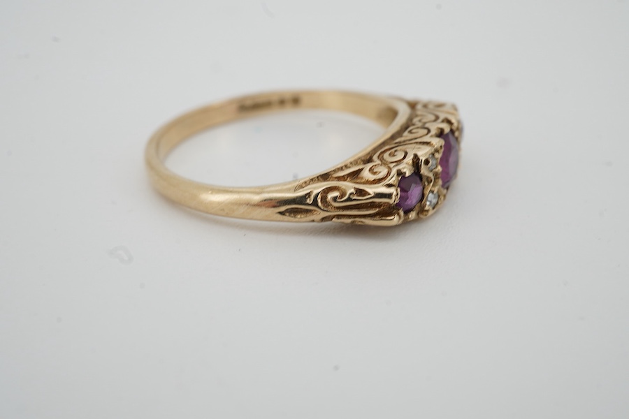 A 1960's 9ct gold ruby and diamond cluster set half hoop ring, size P, gross weight 3.1 grams.
